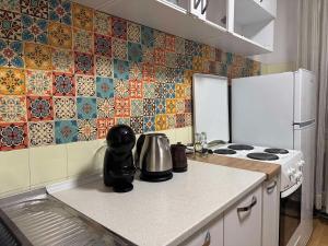 a kitchen with a stove and a refrigerator at Main Square APT with Stone Bridge & Old Bazaar View in Skopje +6 photos