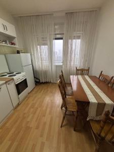 a kitchen and dining room with a table and a table and chairs at Main Square APT with Stone Bridge & Old Bazaar View in Skopje