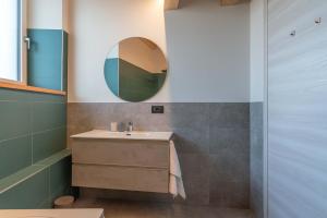 a bathroom with a sink and a mirror at Duplex Cermis in Cavalese +48 photos