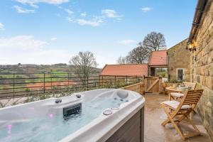 a jacuzzi tub on the patio of a house at 1 Bed in Castleton oc-t34011 in Castleton