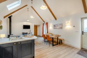 a kitchen and living room with a table and chairs at 1 Bed in Castleton oc-t34011 in Castleton