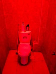 a red bathroom with a toilet in a red room at Silverline Suite in Kitengela 