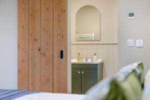 a bathroom with a sink and a mirror and a door at 1 Bed in Castleton oc-t34011 in Castleton +30 photos