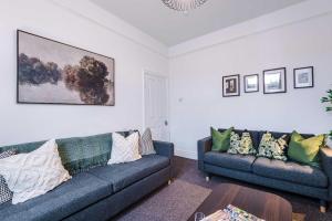 a living room with two couches and a table at Spacious 4 Bed Home in Crewe by 53 Degrees Property! Perfect for Groups & Families in Crewe