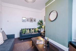 a living room with a couch and a table at Spacious 4 Bed Home in Crewe by 53 Degrees Property! Perfect for Groups & Families in Crewe