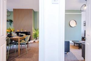 a dining room with a table and chairs at Spacious 4 Bed Home in Crewe by 53 Degrees Property! Perfect for Groups & Families in Crewe +28 photos