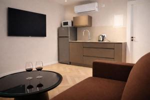 a living room with a table and two wine glasses at Merian Eilat in Eilat