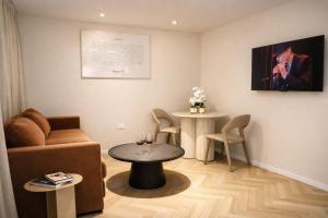 a living room with a couch and a table at Merian Eilat in Eilat