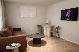 a living room with a couch and a table at Merian Eilat in Eilat +11 photos