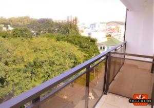 a balcony with a view of trees and bushes at Villa Maior Hotel in São Roque