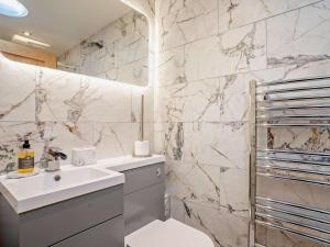 a bathroom with a sink and a toilet at 3 Bed in Brecon oc-92341 in Brecon