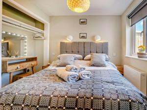 a bedroom with a large bed with towels on it at 3 Bed in Brecon oc-92341 in Brecon