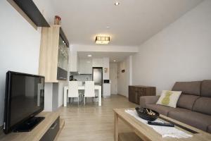 a living room with a couch and a table at AL045 Pinada Beach III La Mata in La Mata