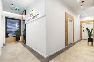 an office lobby with a white wall with a pharmacy sign at Apartamenty EN Zator in Podolsze