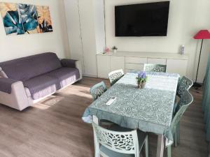 a living room with a table and a couch at Siderno A1passo in Siderno Marina