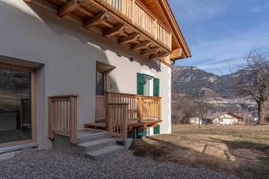 a porch of a house with stairs and a window at Duplex Cermis in Cavalese