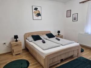 a bedroom with a bed and two night stands at Kinizsi Apartman in Miskolc