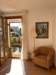 a living room with a couch and a sliding glass door at Appartements am Schlossberg in Starnberg