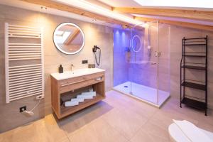 a bathroom with a sink and a shower at Der Berghof in Alpbach