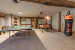 a ping pong table in a room with a ping pong ball at La Maison Rouziès in La Bastide-lʼÉvêque