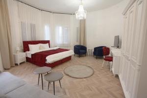 a hotel room with a bed and a tv at Villa Korzo in Bitola