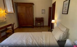 a bedroom with a bed and a desk and a table at Chambre d'hôte domainedesthermesgap in La Celle-sous-Gouzon
