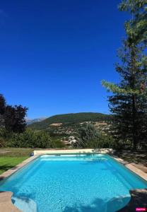 a large swimming pool with a clear blue sky at Chambre d'hôte domainedesthermesgap in La Celle-sous-Gouzon