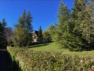 a yard with trees and a house in the background at Chambre d'hôte domainedesthermesgap in La Celle-sous-Gouzon +4 photos
