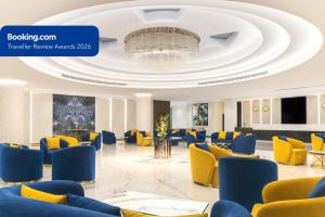 a lobby with blue chairs and yellow chairs at MD Hotel By Gewan in Dubai