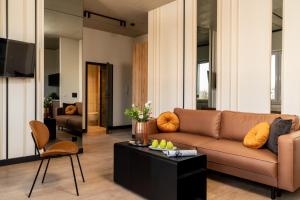 a living room with a couch and a table at ApartHotel S8 - Apartamenty Wrocław in Wrocław