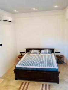 a bedroom with a bed in a white room at Eagle Point Riverside Stay in Weligama +23 photos