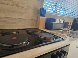 a stove top with some pots and pans on it at Cape Town Glam in Welgemoed