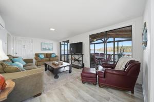 a living room with a couch and a table at Deep Water Stays on Lake Murray in Lake Murray Shores