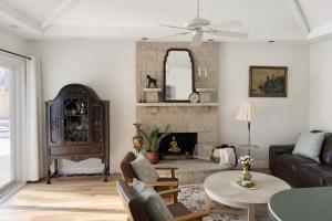 a living room with a couch and a fireplace at Charming Getaway Make Memories in Sterling Heights +38 photos