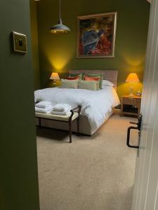 a bedroom with a bed and a painting on the wall at The Lodge in Kelso