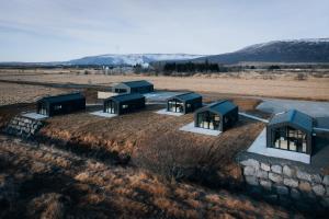 an aerial view of four green buildings in a field at Green Geysir Cottage in Torfastaðir