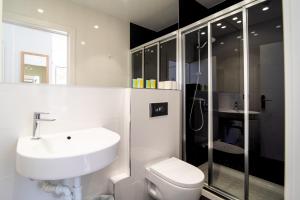 a bathroom with a sink and a shower and a toilet at Central Roomss in San Sebastián