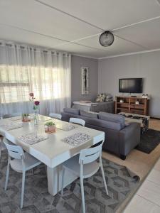 a living room with a table and a couch at Sune's self catering 2 in Worcester