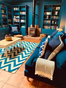 a blue living room with a couch and a fireplace at The Lodge in Kelso