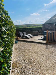 a garden with a bench and a hedge at The Lodge in Kelso
