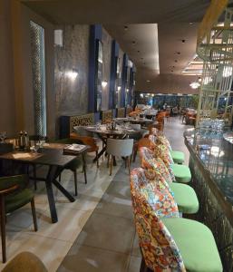 a restaurant with tables and chairs in a room at Villa Korzo in Bitola