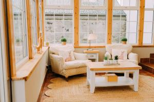 a living room with two chairs and a table at The Lodge in Kelso