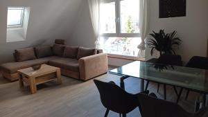 a living room with a couch and a glass table at Walldürn Zentrum 2 in Walldürn