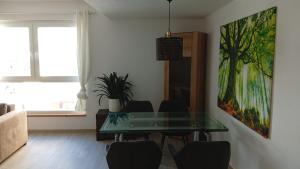 a dining room with a glass table and chairs at Walldürn Zentrum 2 in Walldürn +2 photos