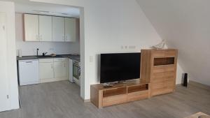 a living room with a flat screen tv in a kitchen at Walldürn Zentrum 2 in Walldürn