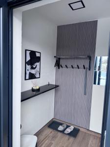 a bathroom with a shower with a black shelf at j ONE Apartmány in Pardubice +9 photos