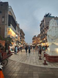 a group of people walking down a city street at Hotel Pilgrim Near Golden Temple in Amritsar