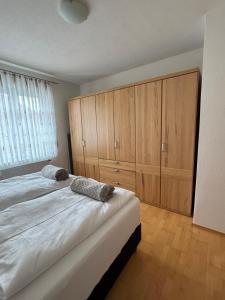 a bedroom with two beds and wooden cabinets at Ferienwohnung zum Utzen in Berching