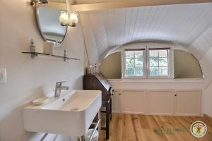 a bathroom with a sink and a mirror at La chaumière in Pleumeur-Bodou +49 photos