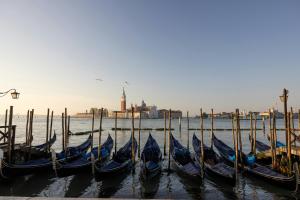 a group of gondolas are docked in the water at Gabrielli Luxury Apartments Venezia - Starhotels Collezione in Venice +27 photos